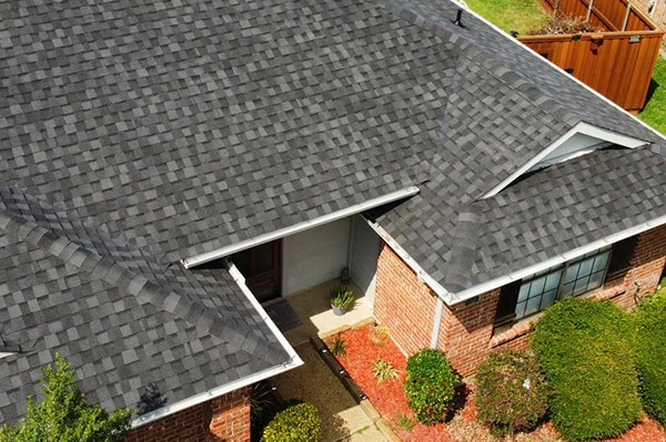 red brick house arial shot with new roof